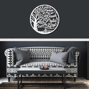 May include: A white metal wall art piece featuring a tree design within a circle. The text "Let everything that has breath praise the Lord" is cut out within the design. Psalm 150:6 is also included.