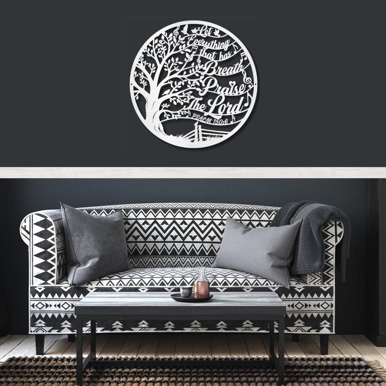May include: A white metal wall art piece featuring a tree design within a circle. The text "Let everything that has breath praise the Lord" is cut out within the design. Psalm 150:6 is also included.
