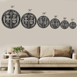 May include: A set of six black metal wall art pieces, each a circular design with the words "Armor of God" and "Ephesians 6:10-20" inscribed. Sizes range from 12 inches to 36 inches in diameter. The design includes a sword, shield, and other religious symbols.