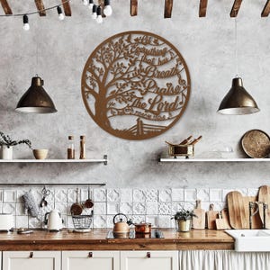 May include: A circular, bronze-colored metal wall art piece featuring a tree design with the words "Let Everything That Has Breath Praise The Lord" and the Bible verse Psalm 150:6. The artwork is displayed on a textured gray wall.