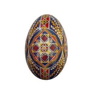 May include: A blue, red, yellow, and white decorated Easter egg with a geometric pattern.