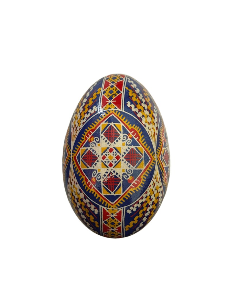 May include: A blue, red, yellow, and white decorated Easter egg with a geometric pattern.