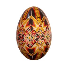 May include: A hand-painted Easter egg with a geometric pattern in shades of red, yellow, black, and white.