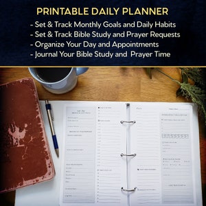 May include: A white daily planner with a black binder, open to a page with sections for "Breathe Out Your Response", "Today's Prayer Requests", "Today's To Do List", "Today's Reminders", "Evening Reflection & Gratitude", and "God's Truth to Reflect On".
