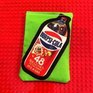 May include: A set of three ceramic mugs with a speckled, matte finish. The mugs are in shades of cream, light gray, and dark gray. Each mug has a simple, minimalist design, perfect for coffee or tea.