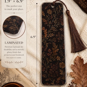 Moody autumn botanical laminated bookmark with brown tassel shown with 1.9 by 6.9 inch dimensions and close-up of the protective laminate finish, styled with fall leaves, vintage books and warm candlelight.