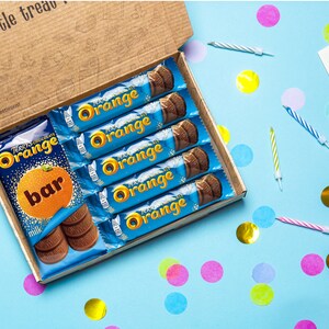 A SweetiePost Gift Box filled with Terry's chocolate orange, including the medium and individual bars. The A5 Terry's chocolate orange hamper by SweetiePost.