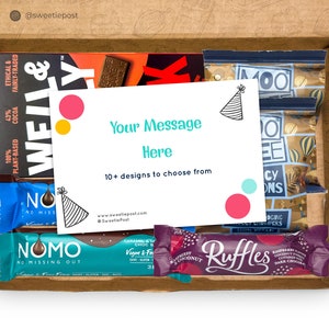 May include: A brown cardboard box with a variety of snacks inside. The box contains chocolate bars, granola bars, and a card with the text "Your Message Here" and a party hat graphic. The card also says "10+ designs to choose from".