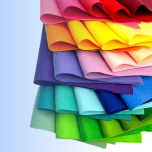 May include: A stack of colorful felt fabric sheets in various shades of red, orange, yellow, green, blue, purple, and pink.
