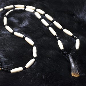 Buffalo tooth necklace with black glass beads