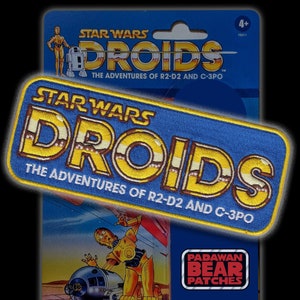 May include: A blue and yellow embroidered patch with the text "STAR WARS DROIDS THE ADVENTURES OF R2-D2 AND C-3PO".