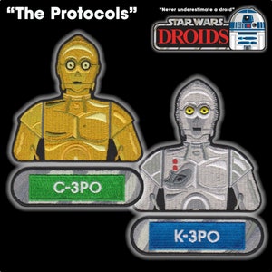 May include: Two embroidered patches featuring the Star Wars Droids characters C-3PO and K-3PO. The patches are gold and silver with the text "The Protocols" and "Never underestimate a droid" above them.