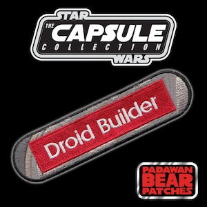 May include: A red and gray embroidered patch with the text "Droid Builder" in white lettering. The patch is part of "The Star Wars Capsule Collection".