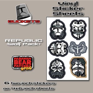 May include: A vinyl sticker sheet featuring six individual stickers with designs of clone trooper helmets and a wolf emblem. The text on the sheet reads Vinyl Sticker Sheets, BUCKETS, REPUBLIC WOLF PACK, PADAWAN BEAR PATCHES & PINS, and 6 two-inch stickers on 4x6-inch sheets.