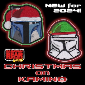 May include: Two embroidered patches featuring Star Wars characters wearing Santa hats. The patch on the left is blue and features a Mandalorian with a red Santa hat. The patch on the right is white and features a Clone Trooper with a green and red Santa hat. The text "New for 2024!" is at the top of the image. The text "Christmas on Kamino" is at the bottom of the image. The text "Padawan Bear Patches & Pins" is in the center of the image.