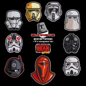 May include: A collection of embroidered patches depicting Star Wars Empire Trooper helmets. The patches showcase designs of Stormtroopers, Scout Troopers, and other iconic characters. The patches are set against a black background, with the text "BUCKETS EMPIRE TROOPERS" and "PADAWAN BEAR PATCHES & PINS".