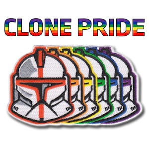 May include: Embroidered patch featuring six stylized clone trooper helmets in a rainbow color scheme. The text "CLONE PRIDE" is displayed above the helmets in rainbow colors. The patches have a white background and a red, orange, yellow, green, blue, and purple outline.