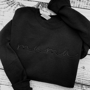 May include: Black sweatshirt with the word "mama" embroidered in cursive on the front.