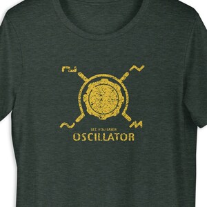 May include: A dark green t-shirt with a yellow graphic of a circuit board and the text "See You Later Oscillator".