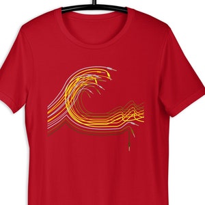 May include: A red short-sleeve t-shirt featuring a graphic design of multiple yellow, white, and brown audio cables arranged in a wave-like pattern. The cables have visible metallic connectors at the ends, creating a stylized, flowing visual effect.