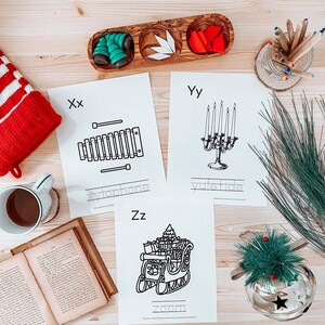 May include: Black and white printable alphabet flashcards with illustrations of a xylophone, a candelabra, and a sleigh. The letters X, Y, and Z are printed on the cards. The words "xylophone", "yuletide", and "zoom" are written below the illustrations.