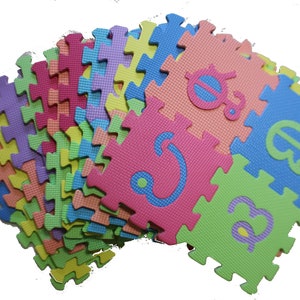 May include: A set of colorful foam puzzle pieces with letters printed on them. The pieces are arranged in a fan shape, with the letters facing outward. The letters are in a variety of colors, including red, blue, green, yellow, and purple.