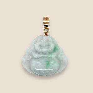 May include: A jade green and white laughing Buddha pendant with a gold bail.