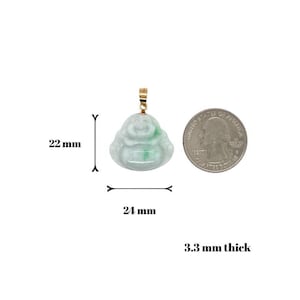 May include: Green jade Buddha pendant with a gold bail. The pendant is 22 mm wide, 24 mm tall, and 3.3 mm thick.