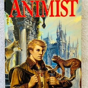 May include: Book cover for "Animist" by Eve Forward. The cover features a young man in a brown jacket, holding a staff, with a wolf and monkey. The title is in large red letters. A castle is in the background.