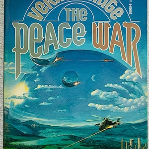 May include: Book cover for "The Peace War" by Vernor Vinge. The cover art features a futuristic scene with aircraft, tanks, and a city skyline. The title is prominently displayed with the author's name. Includes quotes from Publishers Weekly.