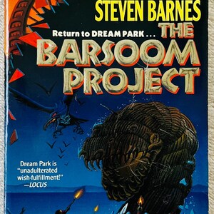 May include: A paperback book titled "The Barsoom Project" by Larry Niven and Steven Barnes. The cover features a dark, fantastical illustration with a large, textured creature and figures holding torches against a blue background.