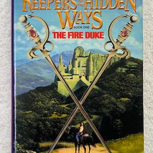 May include: A book cover for "Keepers of the Hidden Ways: The Fire Duke" by Joel Rosenberg. The cover features crossed swords, a castle, and a person on horseback. The title and author's name are prominently displayed.