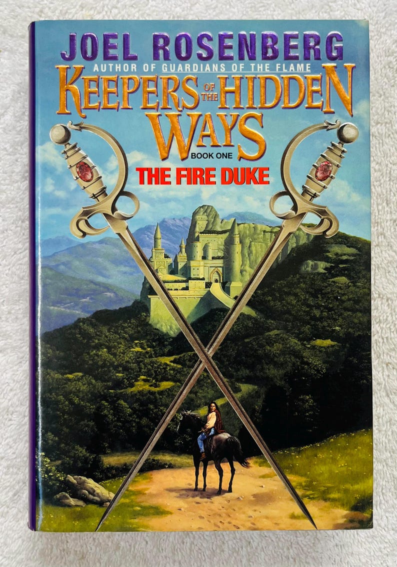 May include: A book cover for "Keepers of the Hidden Ways: The Fire Duke" by Joel Rosenberg. The cover features crossed swords, a castle, and a person on horseback. The title and author's name are prominently displayed.