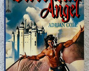 May include: A paperback book cover with the title "Blood Red Angel" in red script. The cover features a muscular man with bat-like wings, a castle, and the author's name, Adrian Cole. The background is a cloudy sky.
