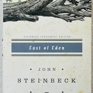 May include: A book cover for "East of Eden" by John Steinbeck. The cover features a detailed black and white illustration of a tree and a landscape. The title and author's name are prominently displayed.