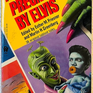 May include: A vintage paperback book cover titled "Alien Pregnant by Elvis." The cover features a green alien with antennae, a baby with a donut in its mouth, and a green hand with long red nails. The background is purple and yellow.