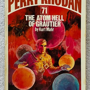 May include: Vintage paperback book cover for "Perry Rhodan" #71, "The Atom Hell of Grautier" by Kurt Mahr. The cover art features a man in a spacesuit surrounded by colorful planets against a red and orange background.