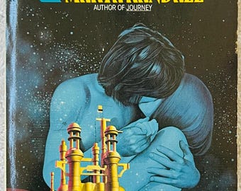 May include: Vintage paperback book cover for "Islands" by Marta Randall. The cover features a blue figure embracing themselves, with a golden city and a starry background. Text includes the title, author, and "Nebula Award Nominee."