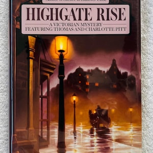 May include: A book cover for "Highgate Rise" by Anne Perry. The cover features a Victorian-era street scene with gas lamps, a horse-drawn carriage, and the title text. The book is a Victorian mystery featuring Thomas and Charlotte Pitt.