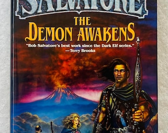May include: A book cover for "The Demon Awakens" by R.A. Salvatore. The cover art features a warrior with a bow, a volcano erupting, and figures in the background. The title and author's name are prominently displayed.