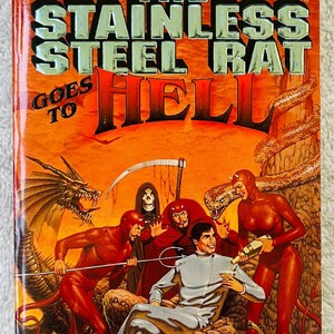 May include: A vintage paperback book cover titled "The Stainless Steel Rat Goes to Hell" by Harry Harrison. The cover art features a science fiction illustration with a man in a silver suit surrounded by red figures and a dragon against an orange background.