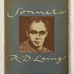 May include: A vintage book cover with the title "Sonnets" in gold script. The cover is a muted teal color, with a sepia-toned portrait of a man in the center. The author's name, R.D. Laing, is also in gold script.