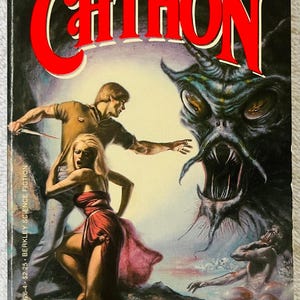 May include: Vintage paperback book cover for "Chthon" by Piers Anthony. The cover art depicts a dramatic scene with a monster, a man with a knife, and a woman in a red dress. The title is in large red letters.