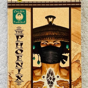 May include: A book cover for "Legend of the Five Rings" featuring a stylized illustration. The cover displays a figure with a black face covering and a straw hat. The title "The Phoenix" is vertically aligned. The author's name, Stephen D. Sullivan, is also visible.