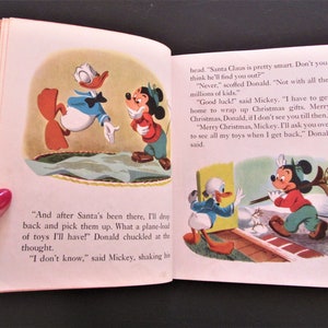 May include: A vintage children's book illustration featuring Mickey Mouse and Donald Duck. Mickey is wearing a red and green sweater and a black hat. Donald is wearing a blue sailor shirt and a red bow tie. The illustration is from a story about Christmas.