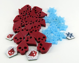 May include: A set of red and blue game pieces. The red pieces are shaped like hearts with a skull design. The blue pieces are shaped like snowflakes.