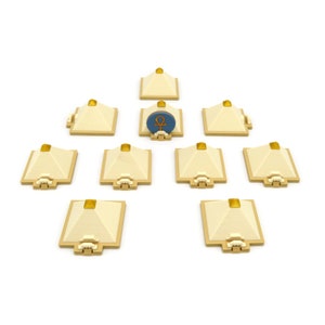 May include: Nine small, beige pyramids with gold tops arranged in a circle around a blue and gold pyramid with an ankh symbol.