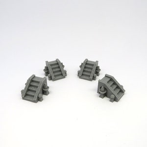 May include: Four gray stone steps with rounded edges and decorative details. Each step has a small, round, gray orb on either side. The steps are arranged in a square pattern on a white surface.