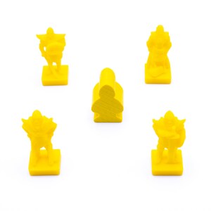 May include: Four yellow plastic game pieces, three are figures with swords and shields, and one is a simple standing figure. The pieces are on a white background.