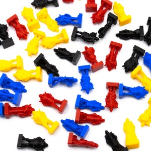 May include: A collection of colorful plastic game pieces in various shapes and colors, including red, blue, yellow, and black. The pieces are scattered on a white surface.